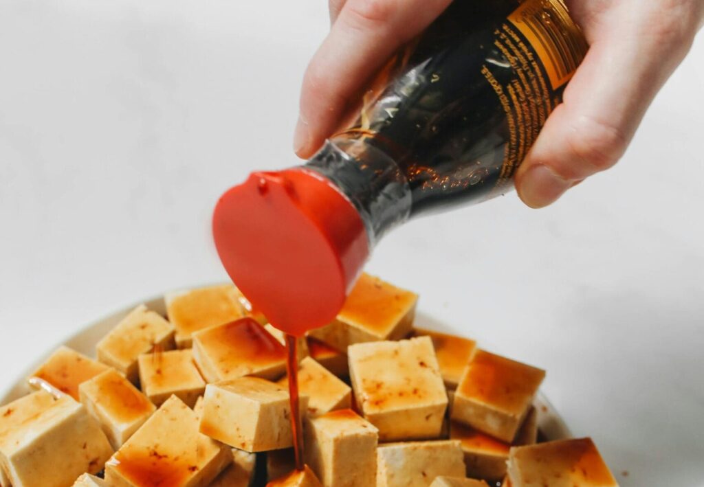 a soy sauce dispenser pouring at the tufo